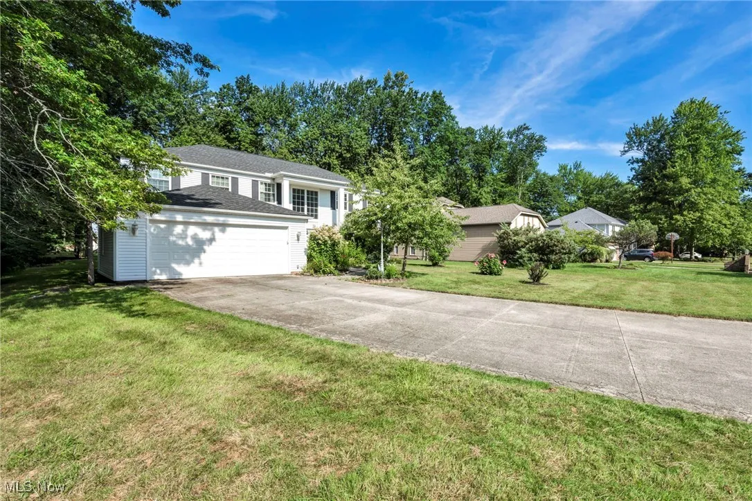 View of front of home with driveway and a front lawn