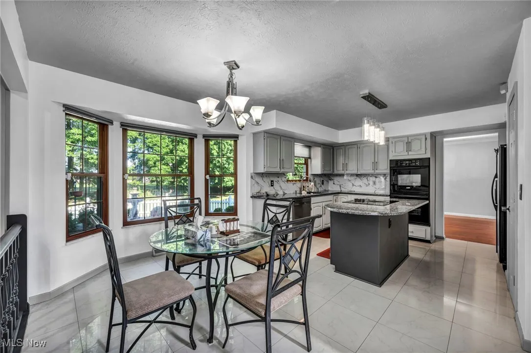 Dining area featuring a chandelier and a textured ceiling