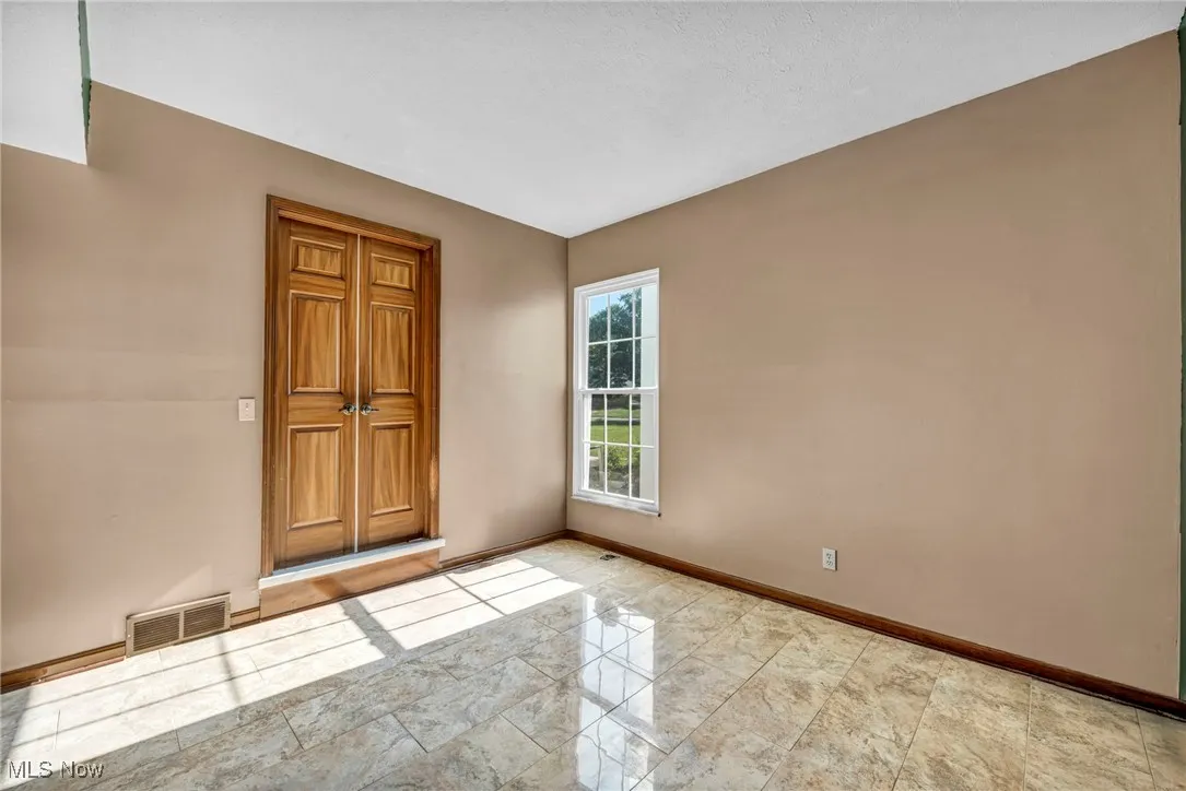 Empty room featuring baseboards