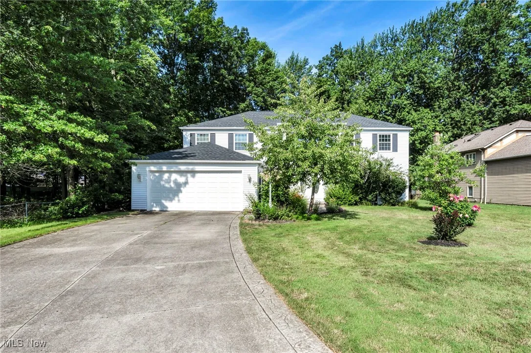 View of front of house with concrete driveway and a garage