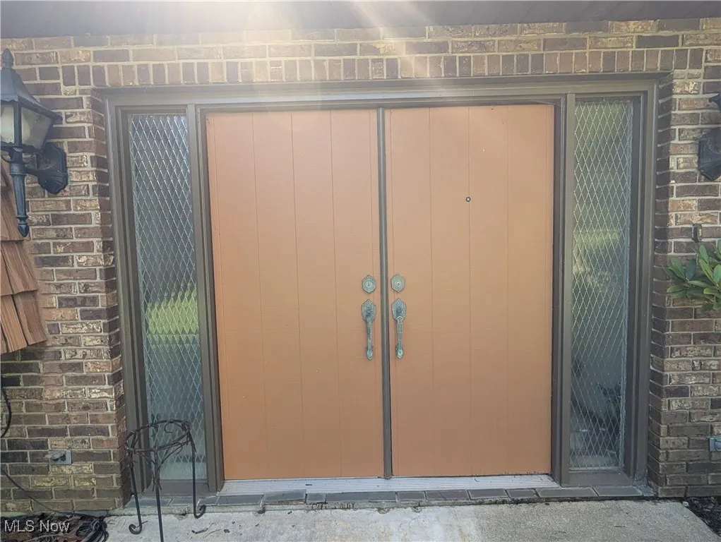 Property entrance with brick siding