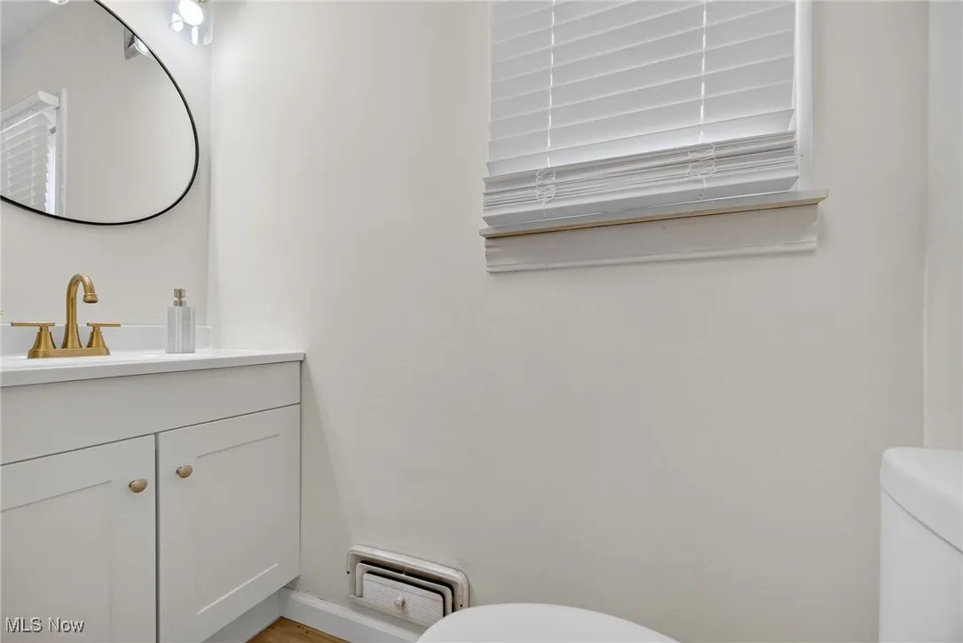Half bath featuring toilet and vanity