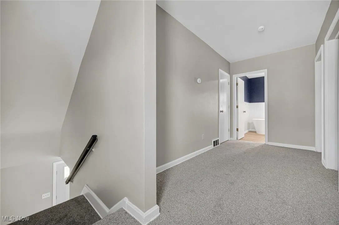 Stairway with carpet and baseboards