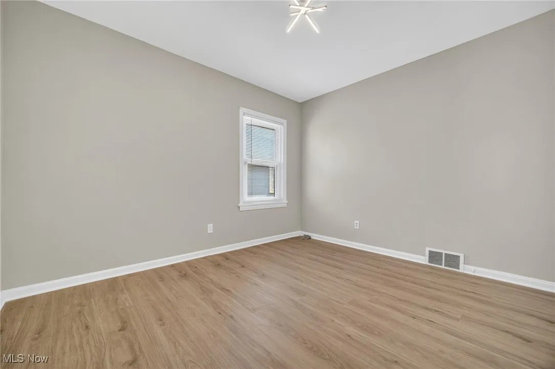 Unfurnished room featuring baseboards and light wood-type flooring