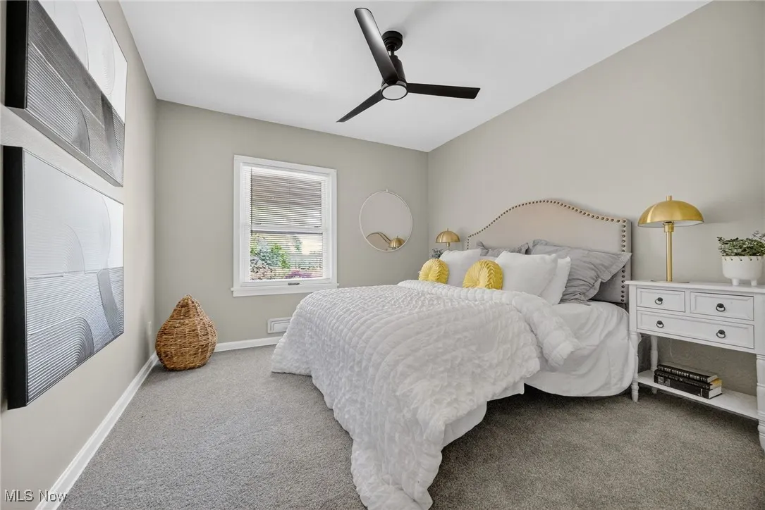 Carpeted bedroom with baseboards and ceiling fan