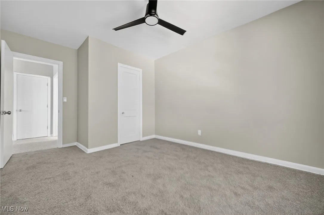 Unfurnished bedroom with carpet flooring and ceiling fan