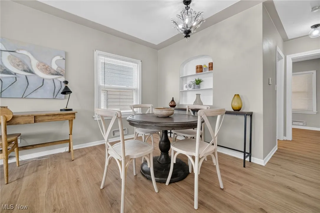 Dining area with light wood-type flooring and a chandelier