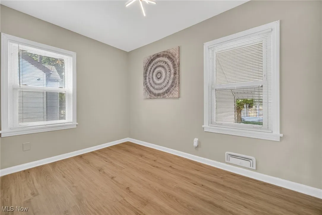 Unfurnished room with baseboards and wood finished floors