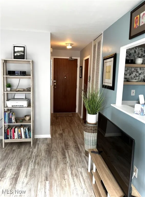 Hall with wood finished floors and baseboards