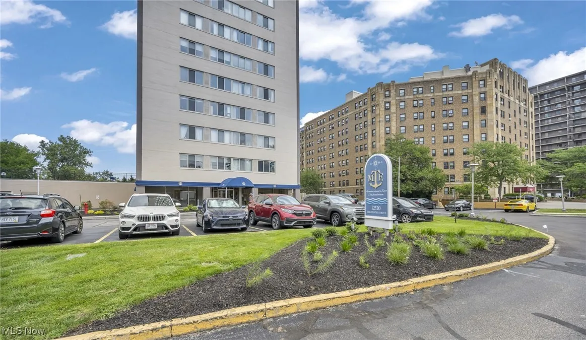 View of apartment building / complex with uncovered parking