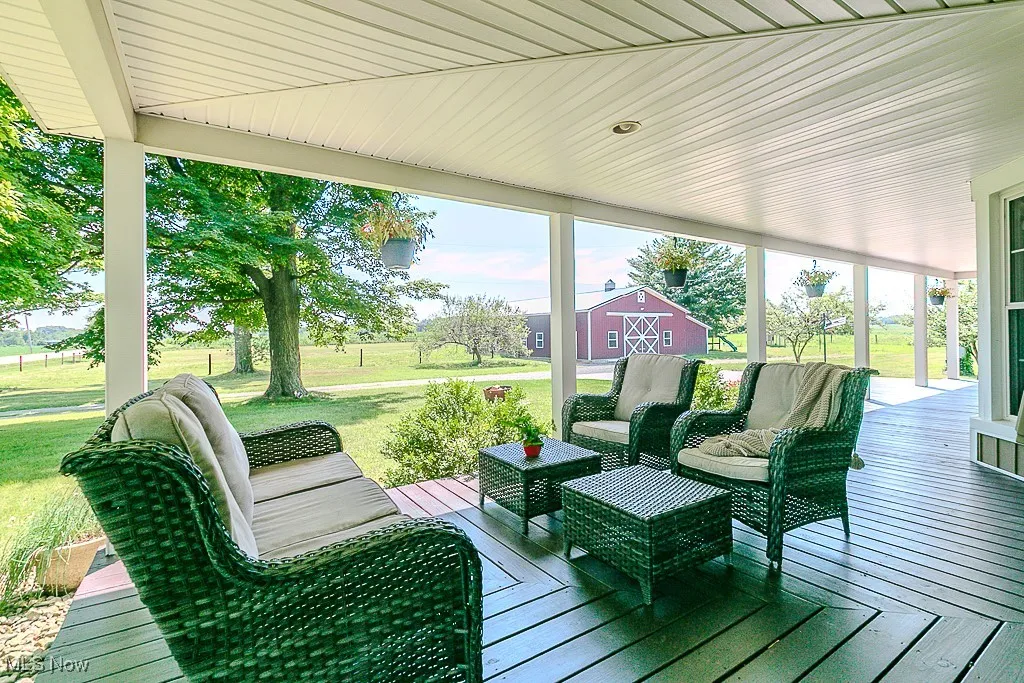 Wooden terrace featuring a lawn