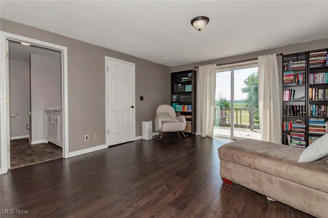Sitting room with wood finished floors and baseboards in the Primary BR
