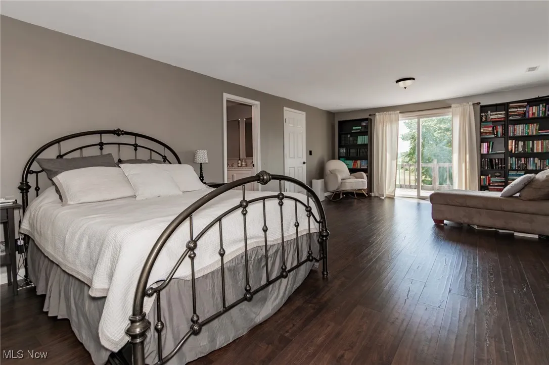 Primary 
Bedroom featuring wood finished floors and access to exterior