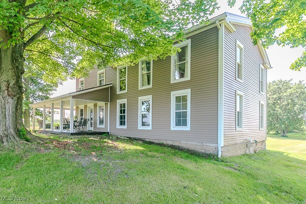 Back of house with a yard