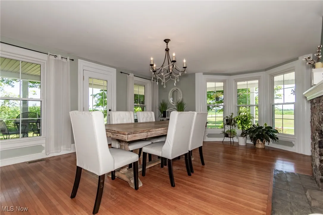Dining room featuring a chandelier, plenty of natural light, and hardwood / wood-style floors