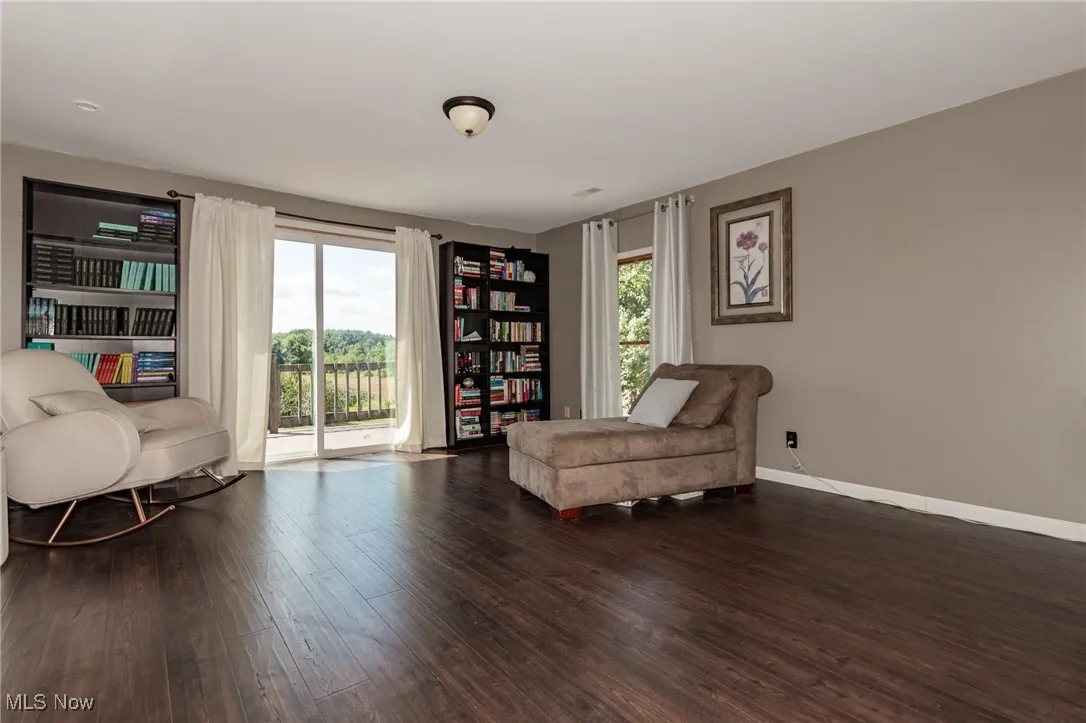 Sitting  area with wood finished floors and baseboards in Primary BR

