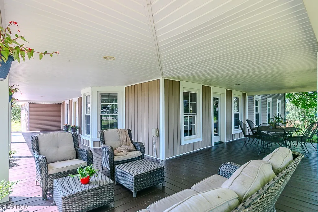 Wooden deck featuring an outdoor hangout area and outdoor dining area