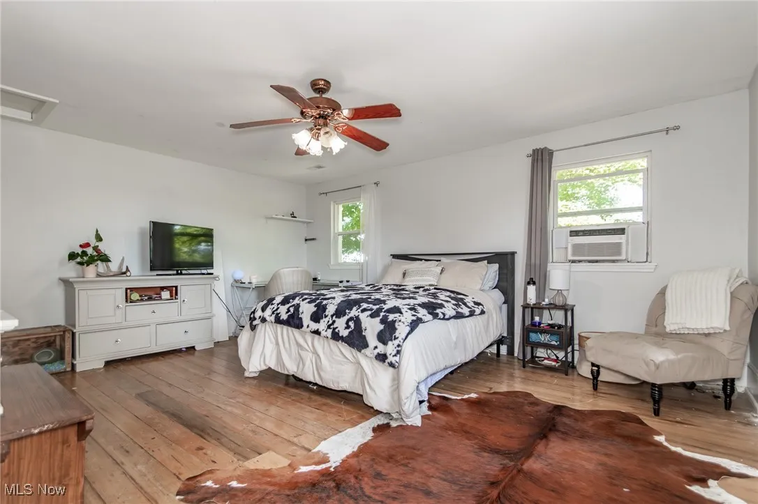 Bedroom 4 featuring hardwood / wood-style flooring and ceiling fan