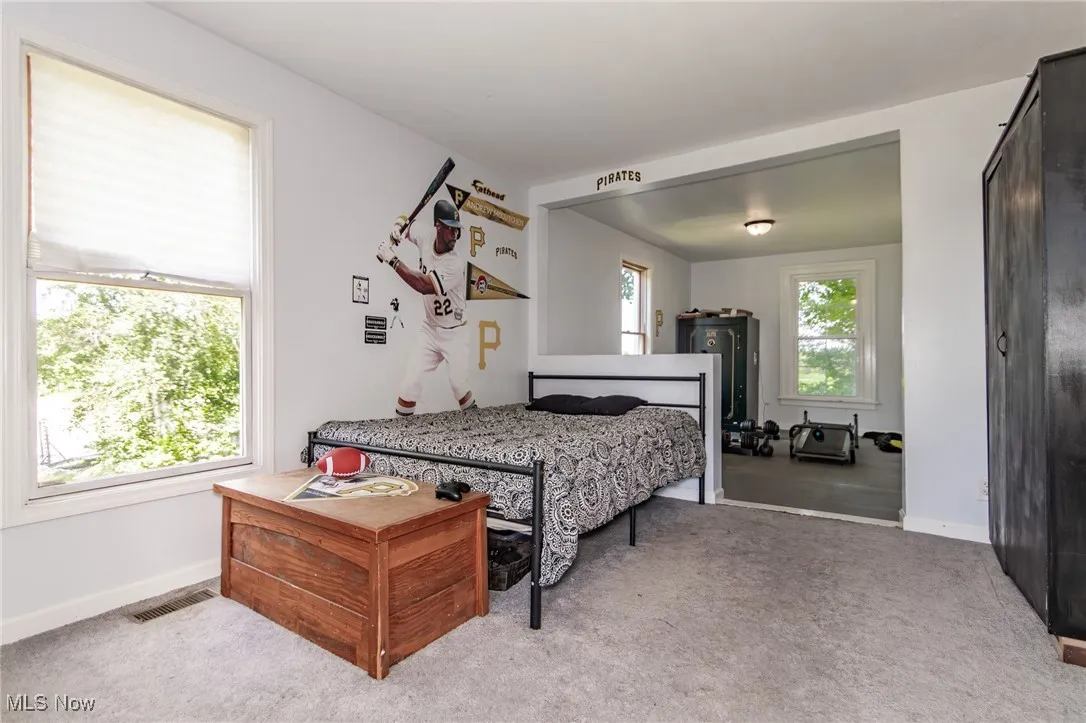 First Floor Bedroom featuring baseboards and carpet flooring