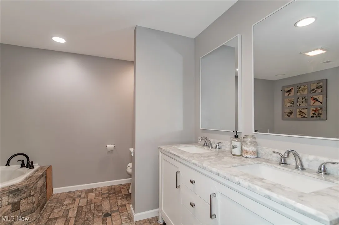 Full Primary bath featuring recessed lighting, double vanity, and a bath