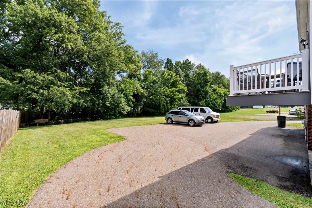 spacious parking and back yard with rear deck view