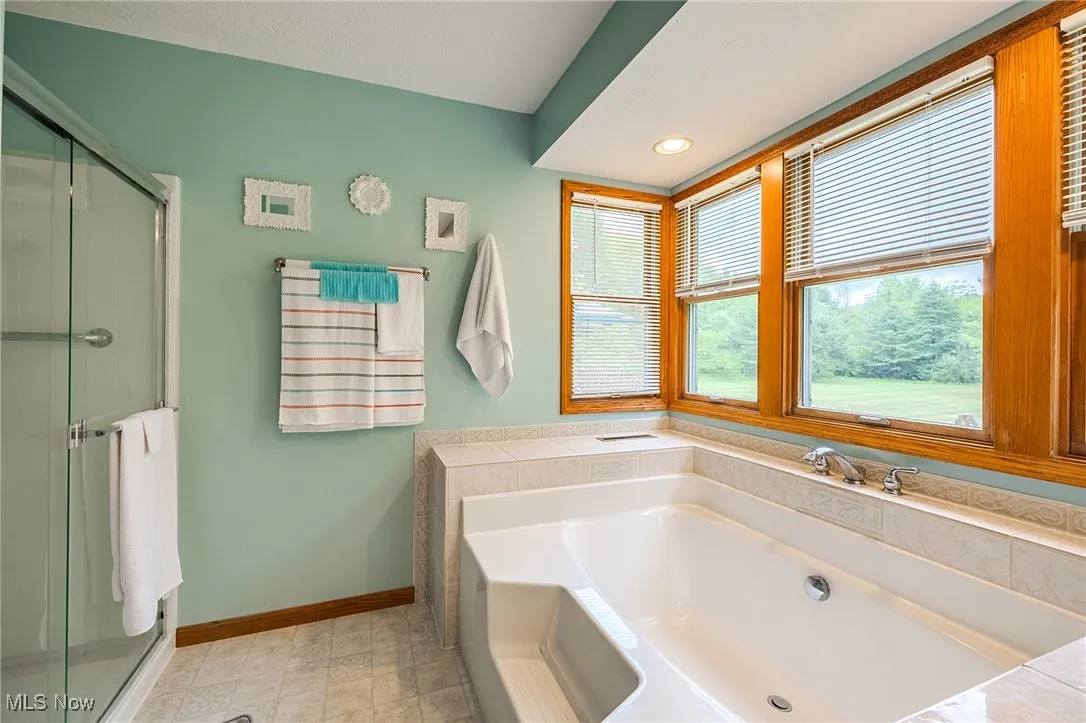 Full bath with a garden tub, a shower stall, and recessed lighting