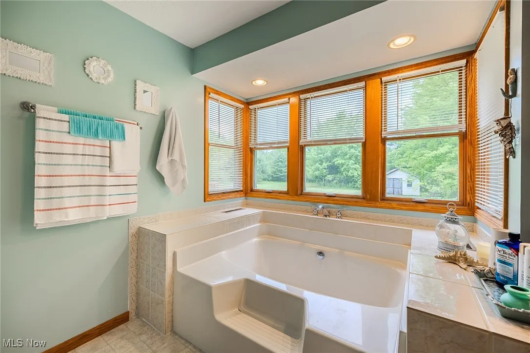 Bathroom featuring a bath and recessed lighting