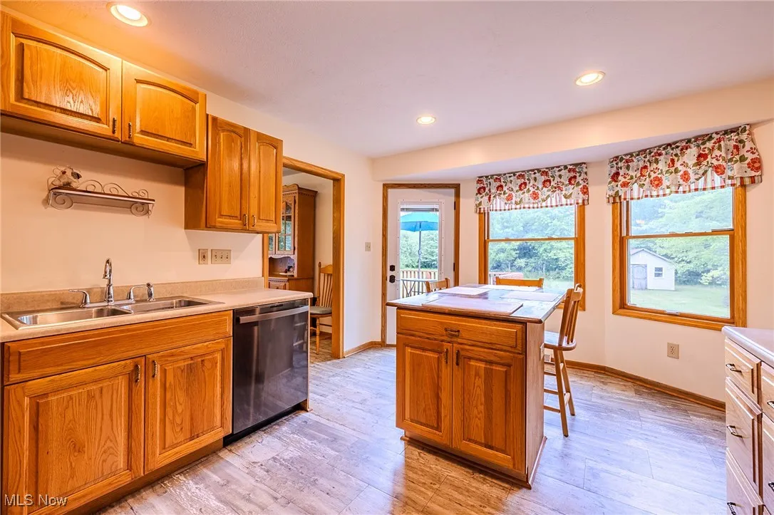 Kitchen featuring recessed lighting, light wood-style floors, stainless steel dishwasher, and light countertops