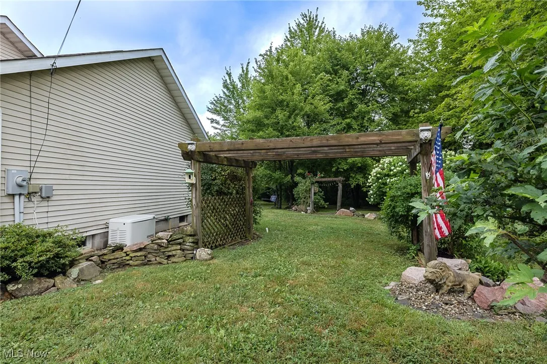 View of green lawn featuring a pergola