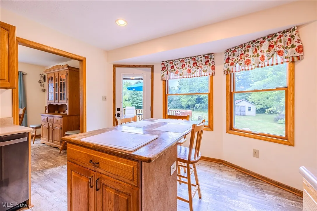Dining space with light wood-style flooring and recessed lighting