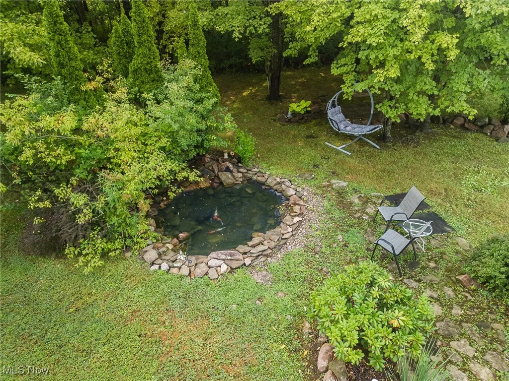 View of grassy yard with a KOI Pond.