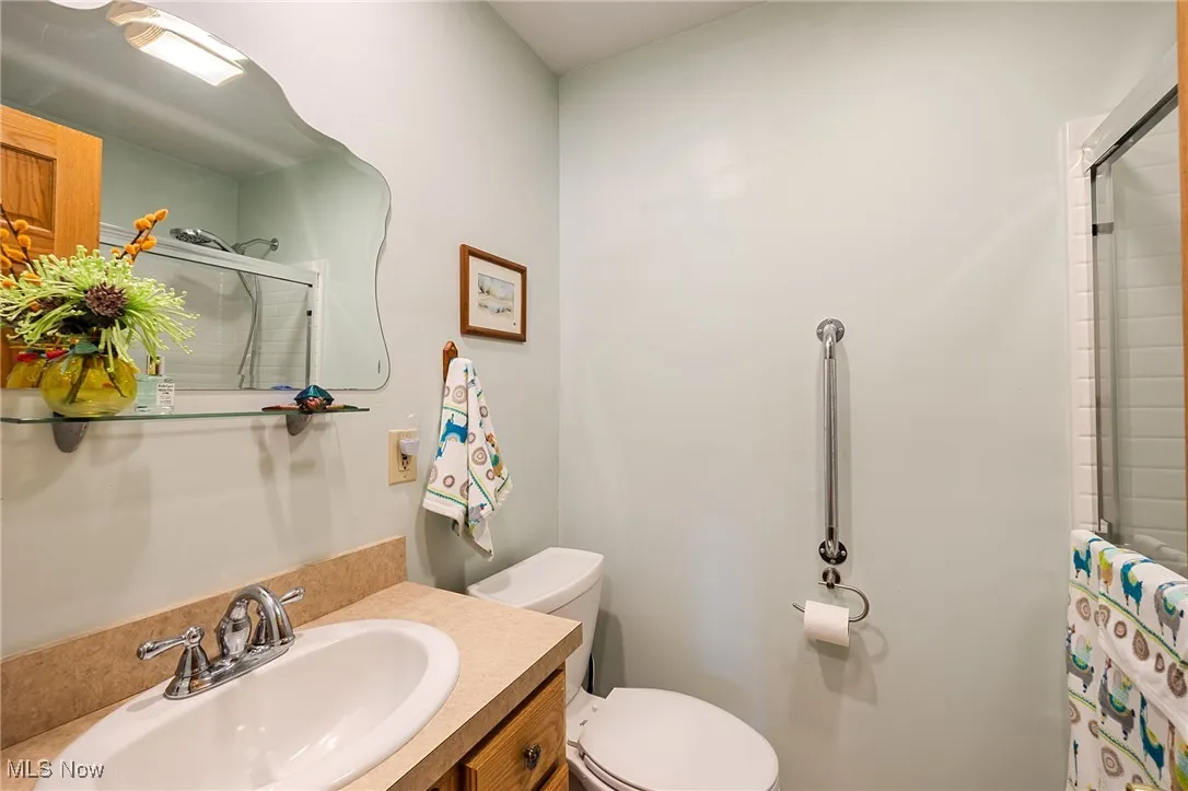 Full bath with a shower with door and vanity