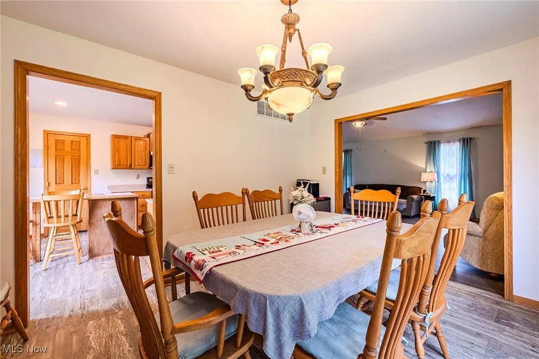 Dining room featuring a chandelier and light wood-type flooring