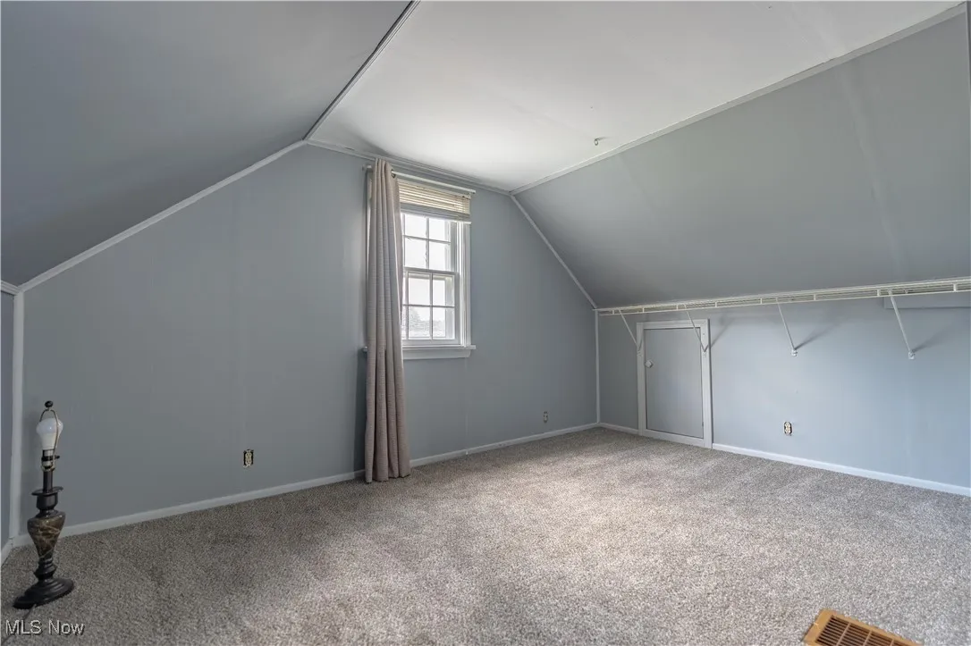 Bonus room featuring carpet floors and lofted ceiling