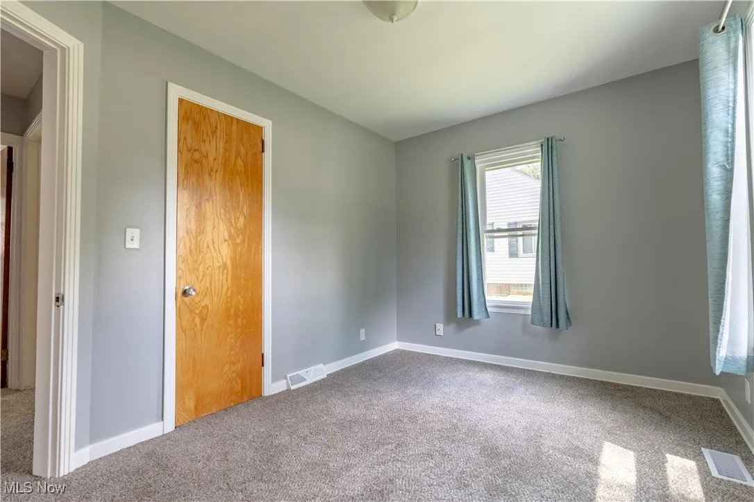 Unfurnished bedroom with baseboards and carpet floors