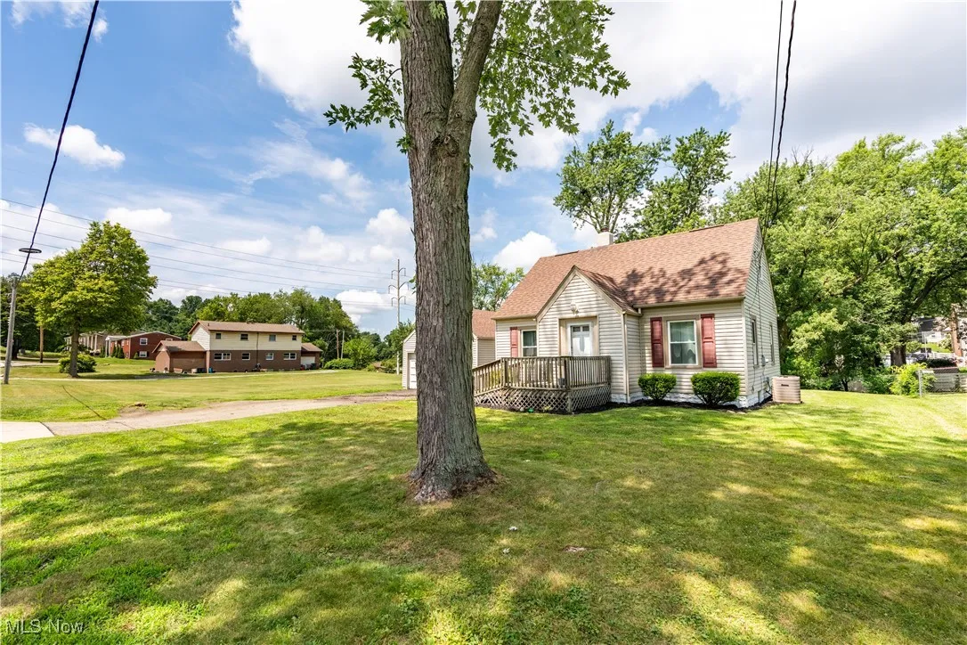 View of front of house with a front lawn and a deck
