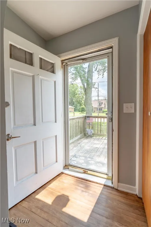 Entryway with wood finished floors and baseboards