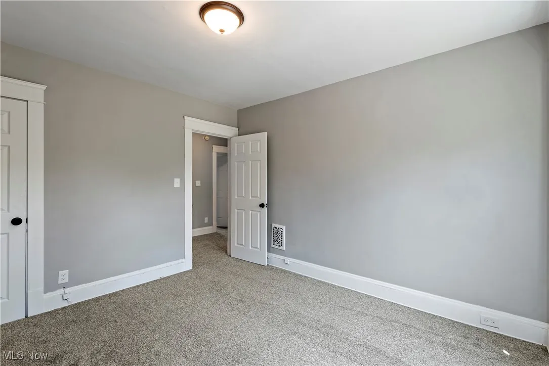 Unfurnished bedroom featuring carpet flooring and baseboards