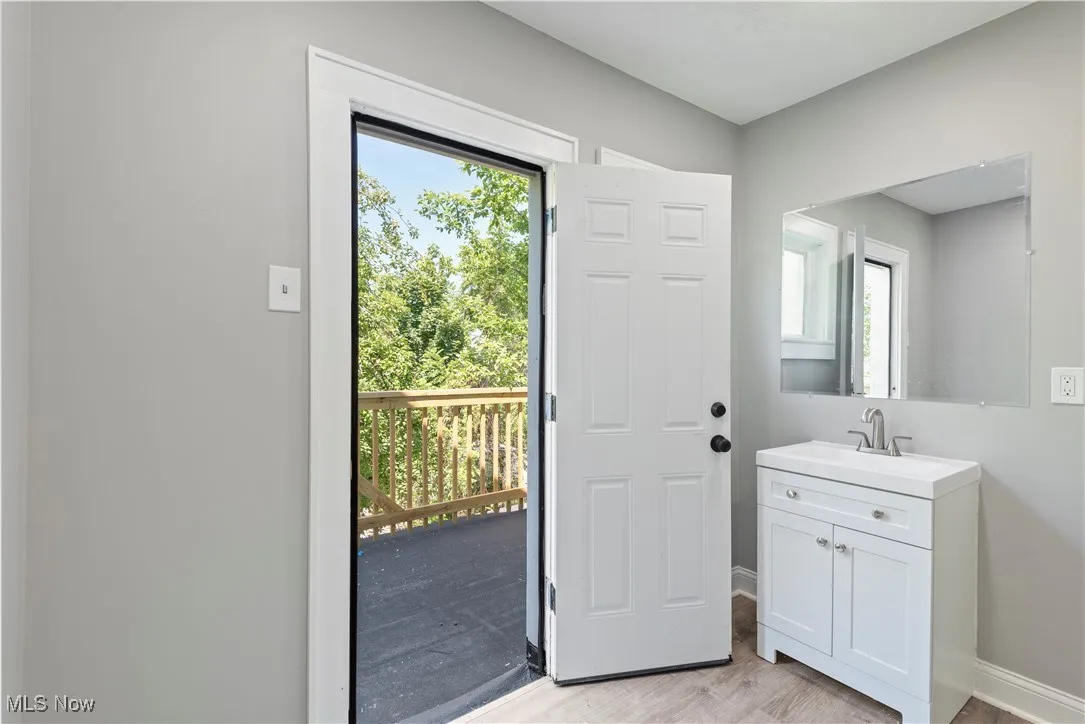 Doorway to outside with light wood-type flooring and healthy amount of natural light