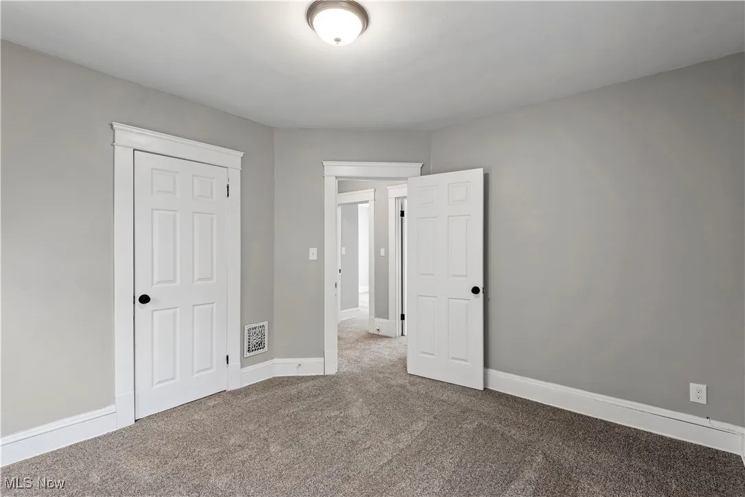 Unfurnished bedroom with carpet floors and a closet