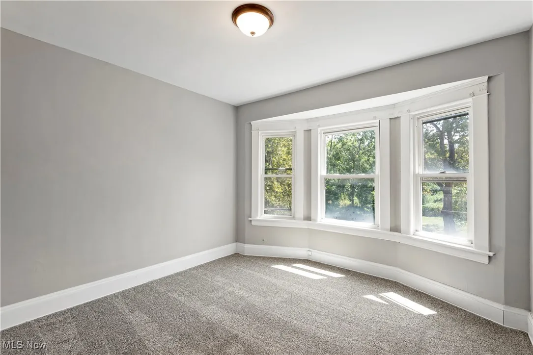 Carpeted empty room with plenty of natural light