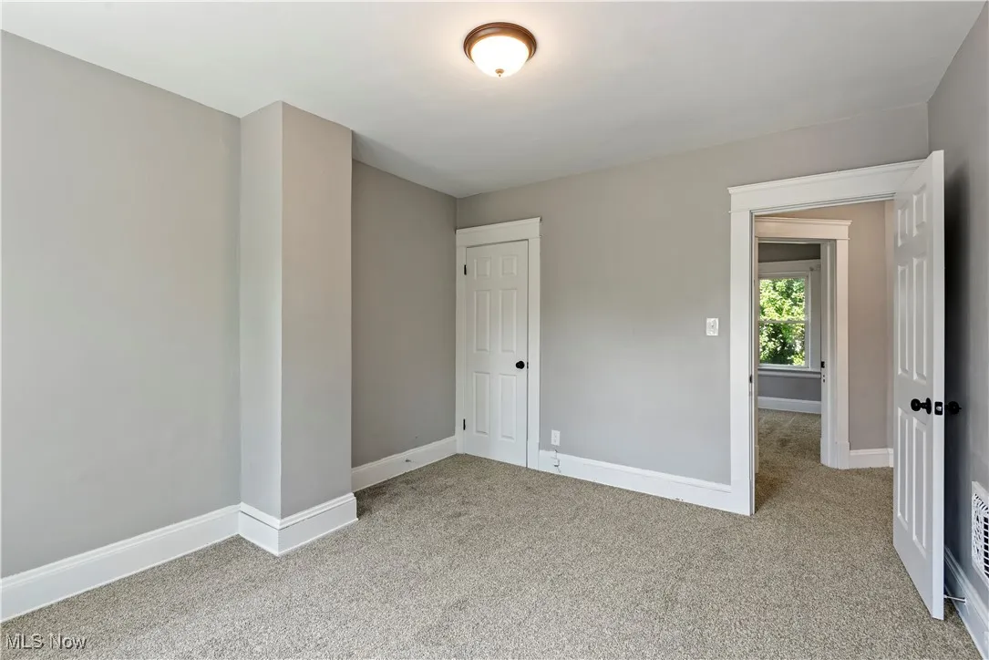 Carpeted spare room with baseboards