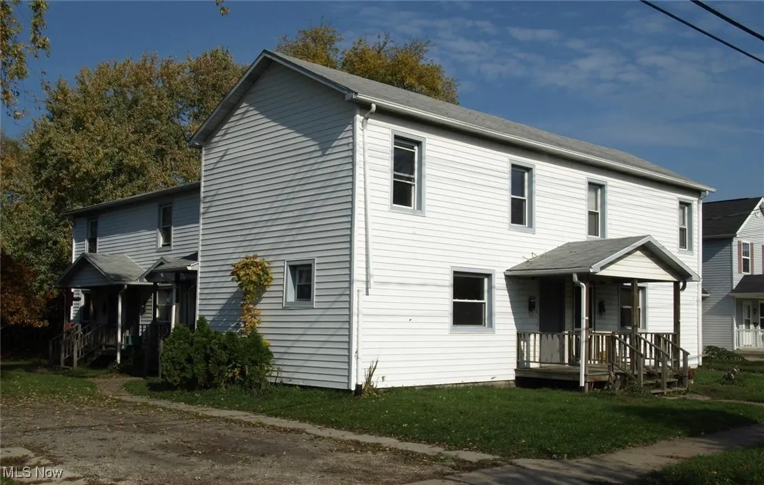 View of front of house featuring covered porch and a front lawn