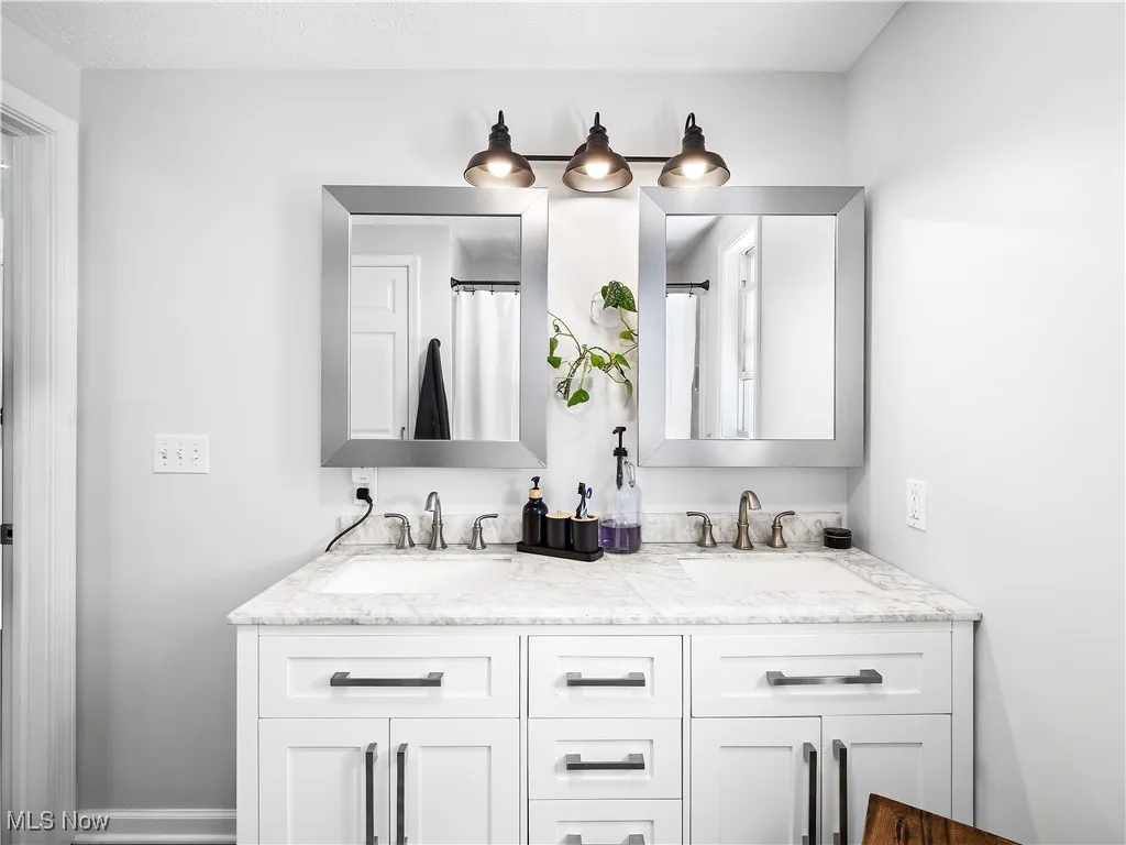 Full bath featuring double vanity