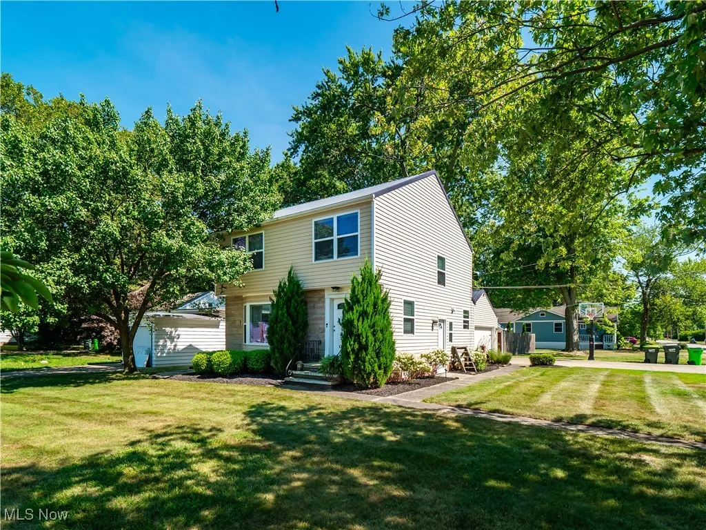 Colonial inspired home featuring large yard