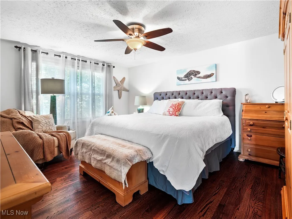 Bedroom featuring dark hardwood floors and ceiling fan