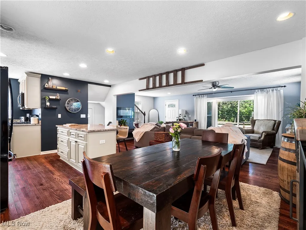 Dining room with dark hardwood flooring open to kitchen and family room