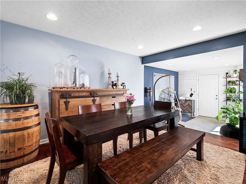 Dining room with dark hardwood flooring open to kitchen and family room