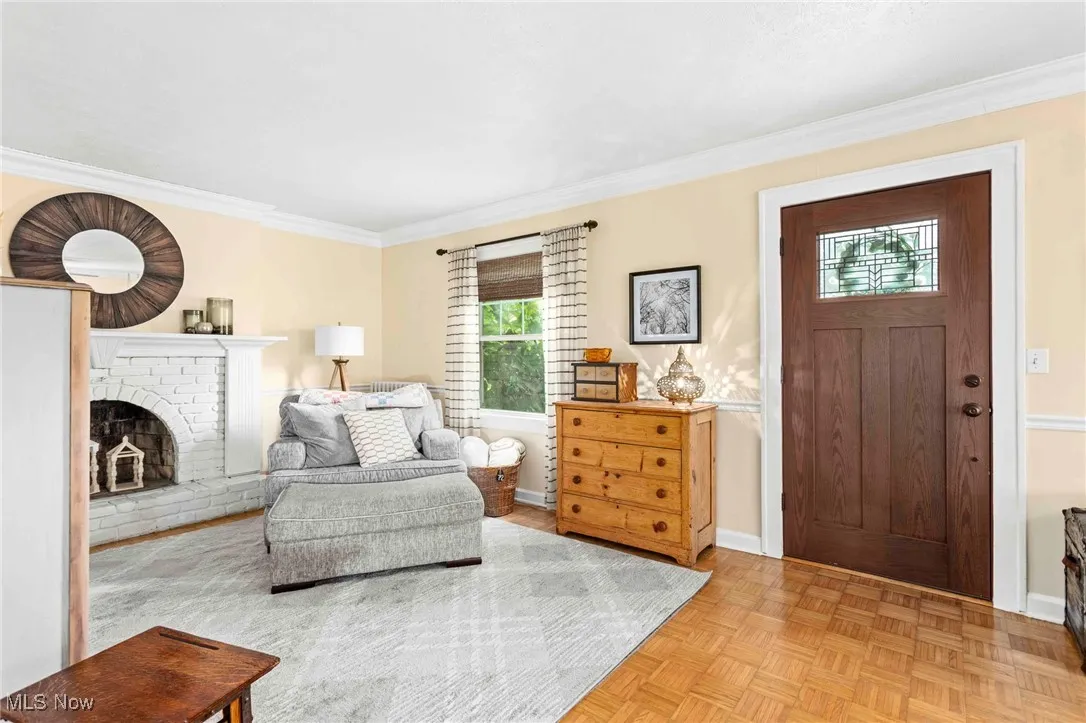 Sitting room featuring crown molding and a fireplace