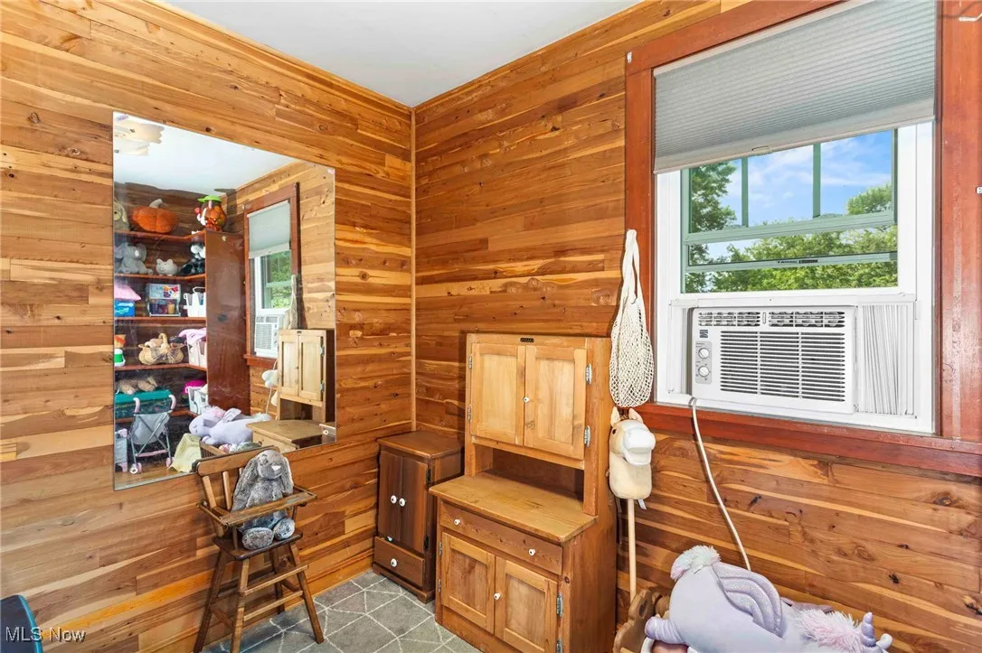 Living area featuring wood walls